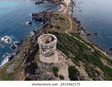 Landscape with hill, old tower and sea coast. Region Iles Sanguinaires, Island Corsica, France
