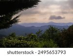 Landscape horizon line in the mountains, pink orange sunset and blue mountains.