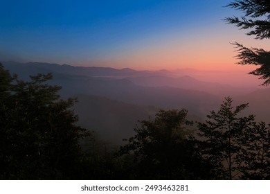 Landscape horizon line in the mountains, pink orange sunset and blue mountains. - Powered by Shutterstock