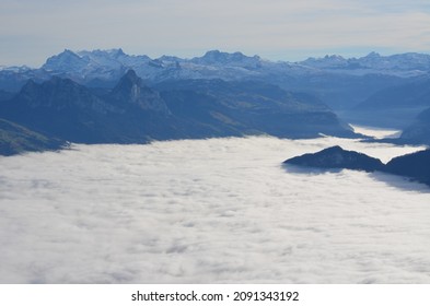 A landscape horizon of mountain peaks above the clouds in the alpine region of Switzerland. - Shutterstock ID 2091343192