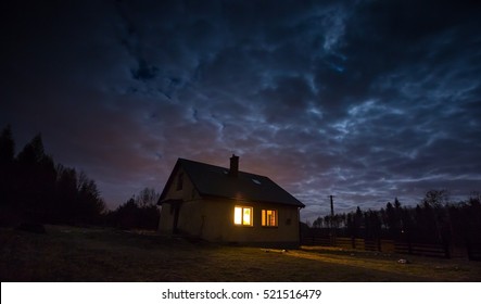 Landscape With House At Night Under Cloudy Sky. Spooky Landscape With House In Night.