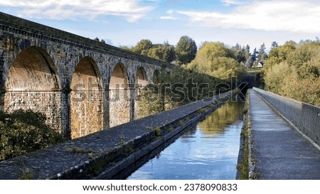 Landscape image of Chirk canal aqueduct water with railway viaduct bridge behind. Historic monument industrial revolution infrastructure engineering.
