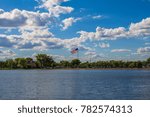 A landscape of a lake and clouds at Wylie Park in Aberdeen, South Dakota, USA.