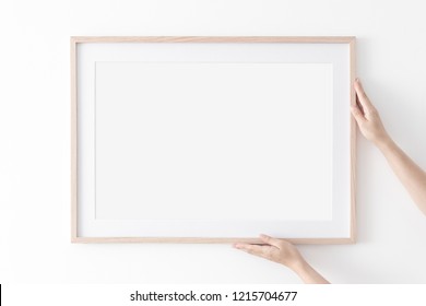 Landscape Large 50x70, 20x28, A3,a4, Wooden Frame Mockup With Passe-partout On White Wall In Women Hands. Poster Mockup. Clean, Modern, Minimal Frame. Empty Fra.me Indoor Interior, Show Text Or