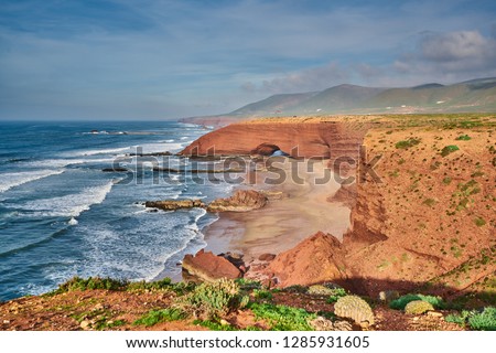 Landscape of Legzira Beach with  its natural arches at the coast of Atlantic ocean. Legzira Beach is located on the ocean coast of Morocco, in Sidi Ifni, close to Agadir.