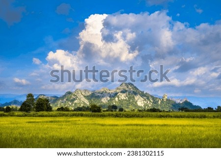Landscape of limestone mountain and rice field, with beautiful clouds on blue sky, travel scenic at Neon Maprang, Phitsanulok, Thailand (Tham Pha Tha Phon)