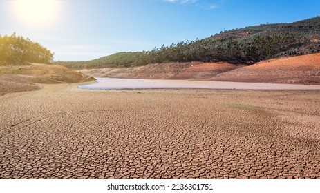 Landscape of low water and dry land in advance, severe drought in the reservoir of Portugal. Ecological disaster, soil dehydration. desert, drought, - Shutterstock ID 2136301751