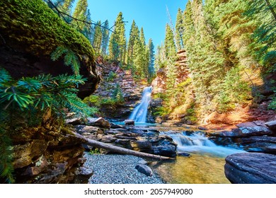 Landscape Of Magical Waterfalls In Gorge Next To Mossy Rock Wall