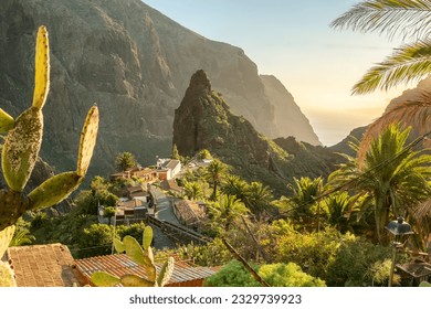 Landscape of the Masca valley at sunset in Tenerife, Canary island, Spain. Scenic mountain landscape with palm trees and tropical vegetation in Tenerife.