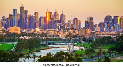 Landscape of Melbourne City over Maribyrnong River and Footscray Park. Crowded modern office buildings in Melbourne's CBD in sunset. 