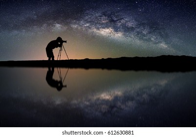 Landscape with Milky way galaxy. Night sky with stars and silhouette Photographer take photo on the mountain.
