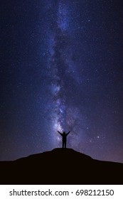 Landscape With Milky Way, Night Sky With Stars And Silhouette Of Happy Man Standing On High Moutain