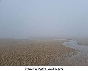 A Landscape Of A Misty Beach Sandy Beach