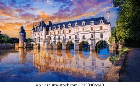 Landscape of the most beautiful Castle in the Loire Valley; Chenonceau reflected in the River Cher illuminated at sunset in Touraine region, France