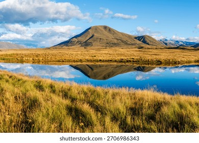 Landscape of Mount Guy reflected in the waters of Lake Clearwater on the South island of New Zealand; nature landscape of alpine mountain range at Ashburton Lakes, Hakatere conservation area 