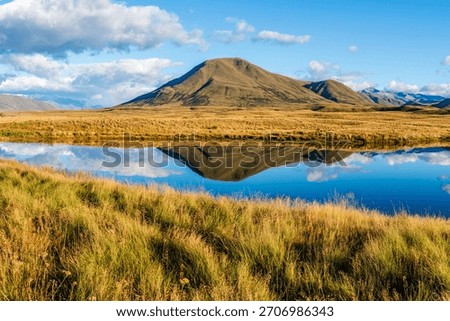 Landscape of Mount Guy reflected in the waters of Lake Clearwater on the South island of New Zealand; nature landscape of alpine mountain range at Ashburton Lakes, Hakatere conservation area 