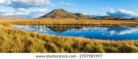 Landscape of Mount Guy reflected in the waters of Lake Clearwater on the South island of New Zealand; nature landscape of alpine mountain range at Ashburton Lakes, Hakatere conservation area