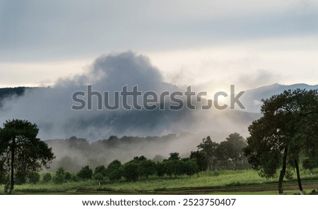 Similar – Image, Stock Photo Mountains covered with fog near lake in Thailand