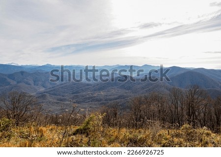 Landscape of a mountain range on an autumn morning. Panoramic view of the Caucasus mountains. View of the mountain range under a cloudy sky. Mountain landscape with beautiful Caucasian nature. 