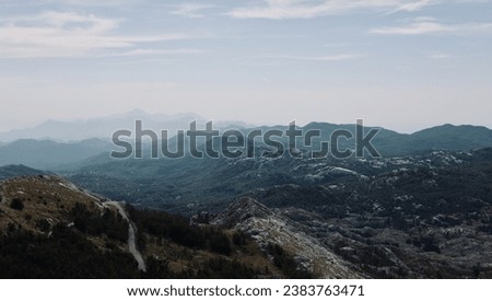 Landscape of a mountain range. Panoramic view of the Lovchen mountains. View of the mountain range under a cloudy sky. Mountain landscape with beautiful nature. 
