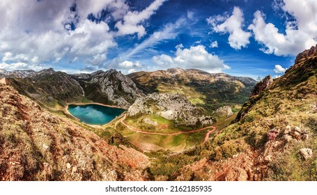 Landscape of a mountain valley of hills with a lake. Beautiful mountain valley panorama. Mountain valley panoramic landscape. Mountain landscape