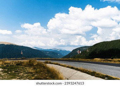 Landscape with mountains, green hills and cloudy sky, Transalpina road, Romania.