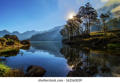 landscape with mountains trees and a lake in front segara danau anak lake, Mount Rinjani, Lombok, Indonesia. Copy Space Area
