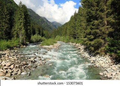 Landscape with mountains trees and a river in front