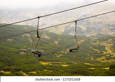 Landscape with mountains and two empty ski lifts.