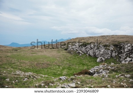 landscape, mountaintop, rocks, grass and sky
