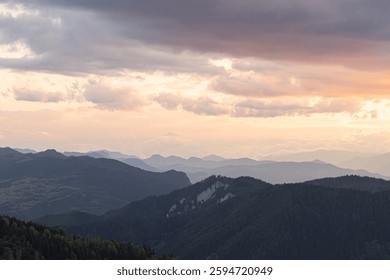 Landscape of the mountrain range and partly cloudy sky at sunset. Nature background photo.