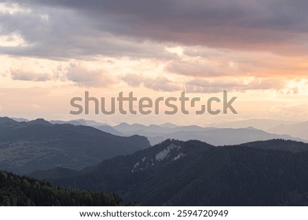 Landscape of the mountrain range and partly cloudy sky at sunset. Nature background photo.