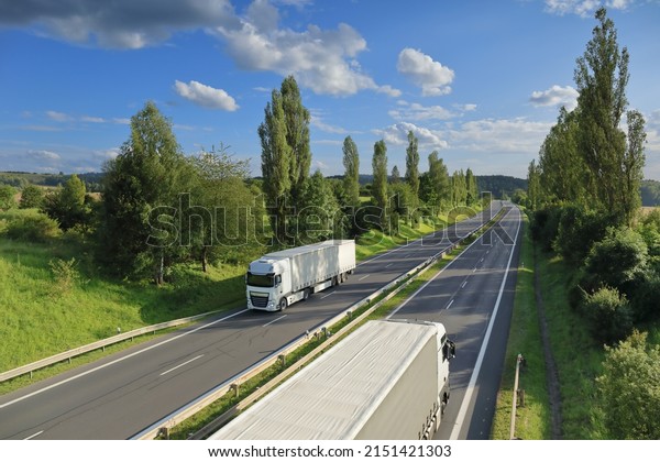 Landscape with a\
moving truck on the\
highway.