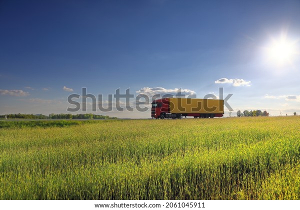 Landscape with a moving\
truck at sunset 