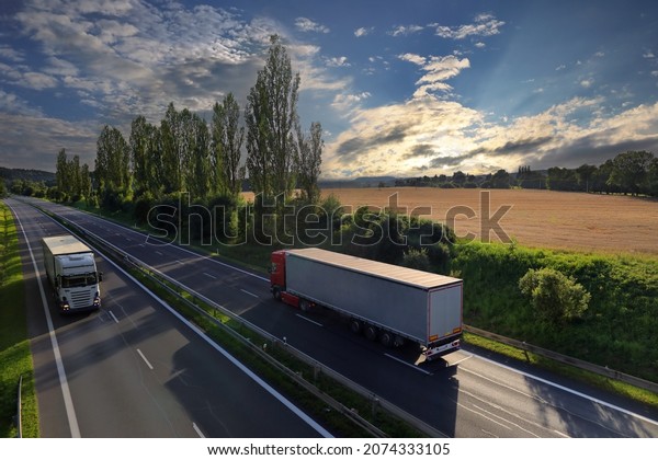Landscape with a moving\
truck at sunset