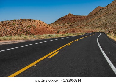 Landscape With Orange Rocks, Sky With Clouds And Asphalt Road In Summer. American Roadtrip