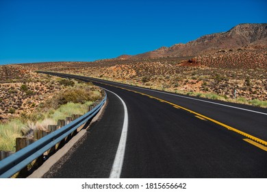 Landscape With Orange Rocks, Sky With Clouds And Asphalt Road In Summer. American Roadtrip