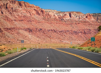 Landscape With Orange Rocks, Sky With Clouds And Asphalt Road In Summer. American Roadtrip.