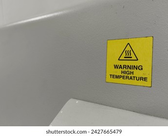 landscape orientation - side view , signs or writing warning of high temperatures in the form of stickers attached to the wall