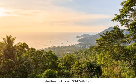 Landscape panorama of tropical Koh Tao island in Thailand. Greenery, nature and view on sea and shoreline from the high-angle during the colorful sunset