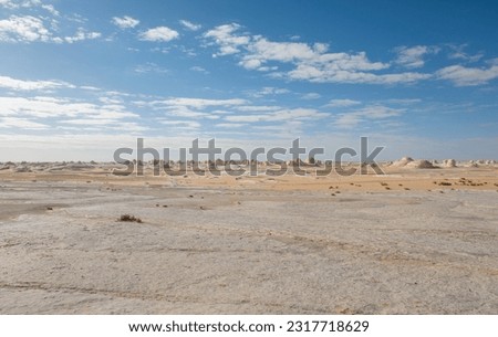 Landscape panoramic scenic view of desolate barren western white desert in Egypt with geological chalk rock formations