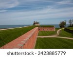 Landscape photo of Fort Niagara park with leading lines of the brick wall leading to the fortress and lake ontario in the distance