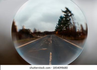 Landscape Photographed Through A Glass Sphere. Forest Around The Road.