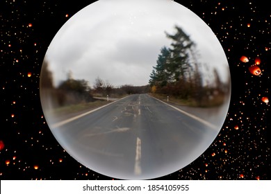 Landscape Photographed Through A Glass Sphere. Forest Around The Road.