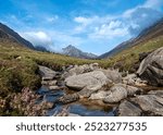 Landscape photography of mountains and valley Glen Rosa, rocky river, viewpoint; blue sky with clouds; travel; hiking and hillwalking, Scotland; UK; Isle of Arran