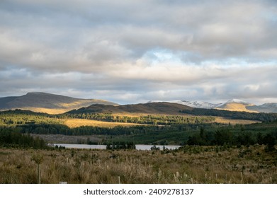 Landscape photography of the Scottish Highlands in the fall. Beautiful scene with mountains and green grass 