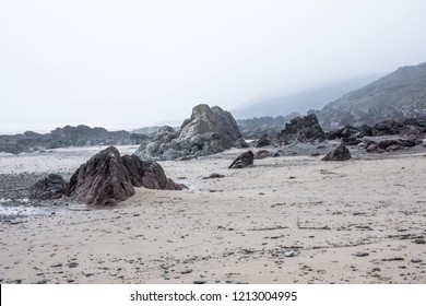 Landscape photography.Morning breeze  on magical rocky beach in Freshwater West,Pembrokeshire,South Wales,UK.Nature image.Foggy weather on british coast.Beautiful and tranquil scenery.