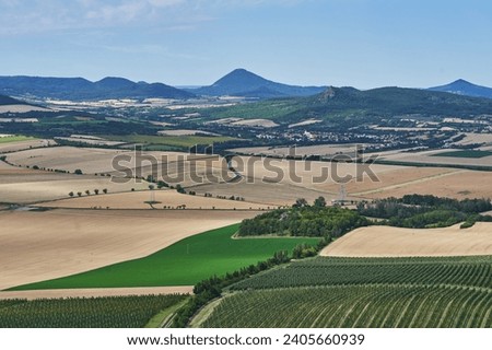 Landscape picture of the cultural country of Central Bohemian Uplands a geomorphological region in northern Bohemia of Czech Republic with intensive agricultural crop production and apple orchards. 