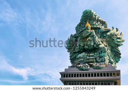 Landscape picture of old Garuda Wisnu Kencana GWK statue as  Bali landmark with blue sky as a background. Balinese traditional symbol of hindu religion. Popular travel destinations in Indonesia.