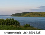 Landscape: the river flows between two green banks. High quality photo